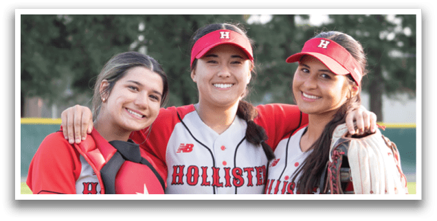 Three female softball players pose for a photo on the field. AI generated content