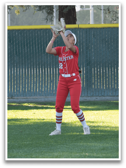A woman in a red outfit catches a ball in a field. AI generated content