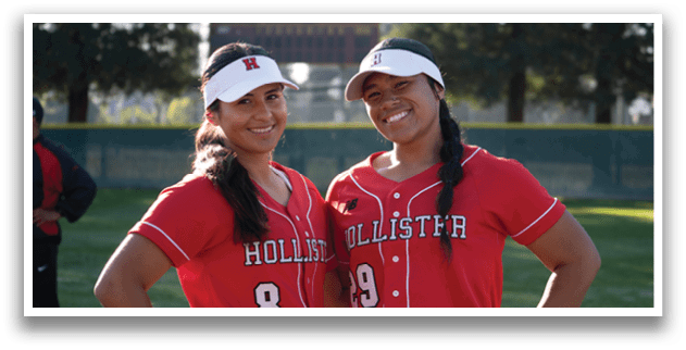 Two female softball players pose for a picture in their red uniforms. AI generated content