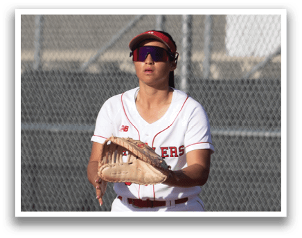 Two girls playing softball, one throwing a ball and the other catching it. AI generated content