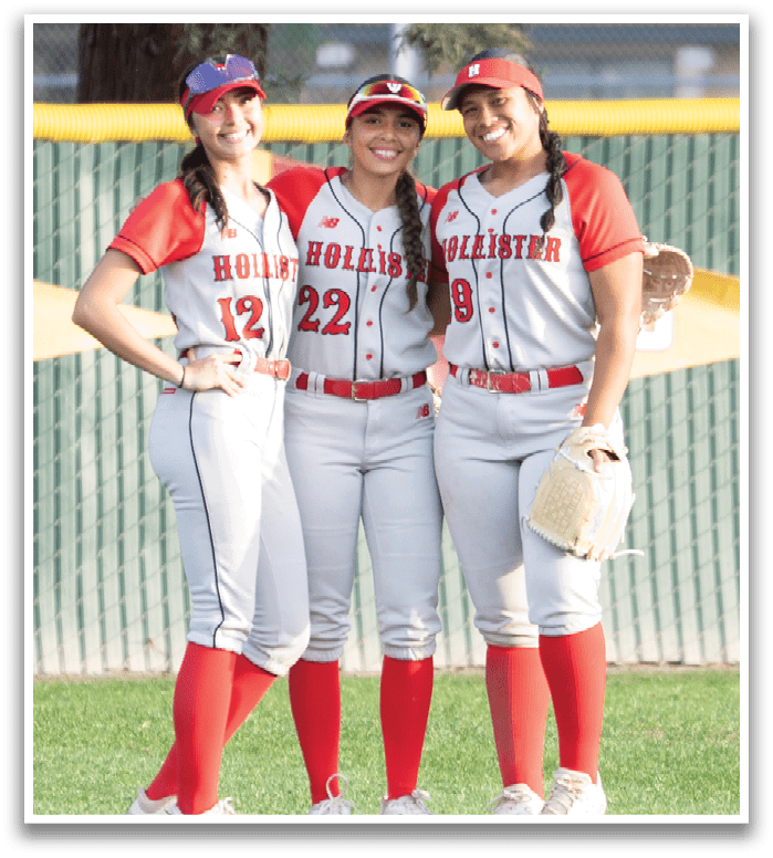 Two female softball players pose for a picture on the field. AI generated content