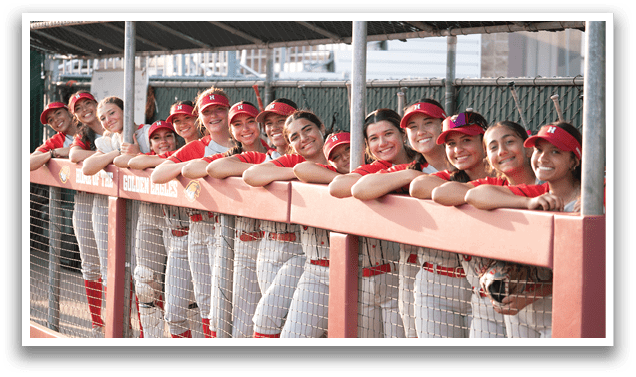 A group of young women wearing red and white uniforms are standing on a baseball field. AI generated content