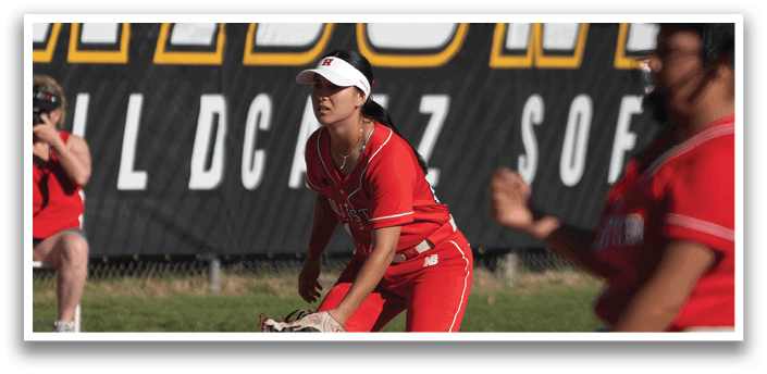 Three female softball players are on the field, with one player in the process of throwing the ball. AI generated content