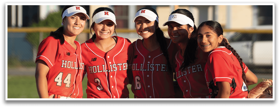 A group of five female softball players posing for a picture on a field. AI generated content