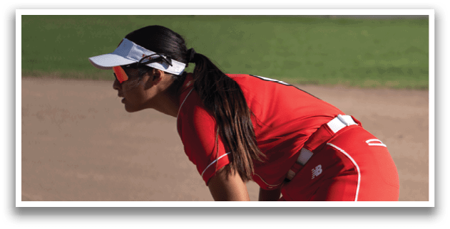 A woman in a red shirt and white hat is playing baseball. She is holding a catcher's mitt and appears to be ready to catch a ball. AI generated content