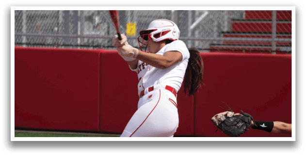 A female baseball player is swinging a bat, attempting to hit a ball. AI generated content