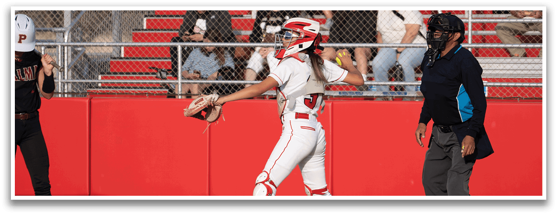 A female baseball player is holding a bat, preparing to swing at a pitch. She is wearing a helmet and a white uniform. There are several other people in the scene, some of whom are sitting on a bench and watching the game. AI generated content