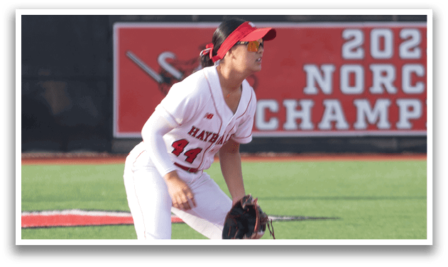 Two female baseball players on a field, one running towards the base. AI generated content