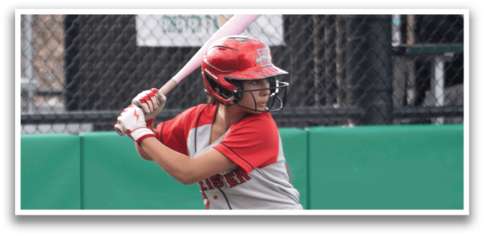 A girl is swinging a bat at a ball. Description generated by AI