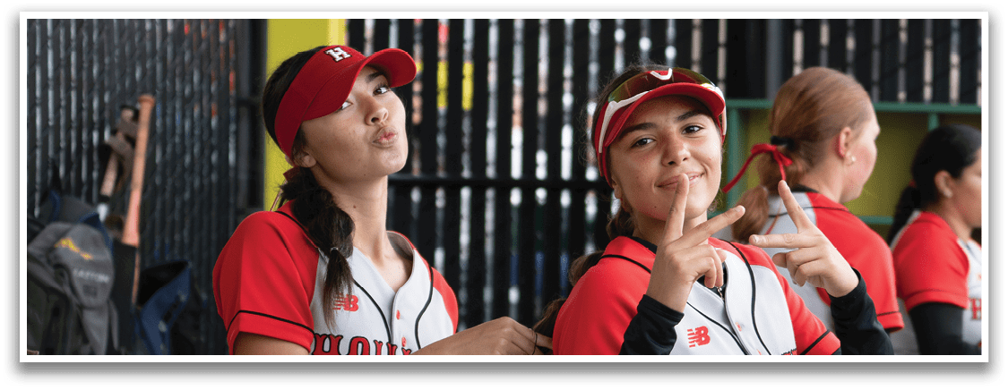 A group of women wearing red and white uniforms. Description generated by AI