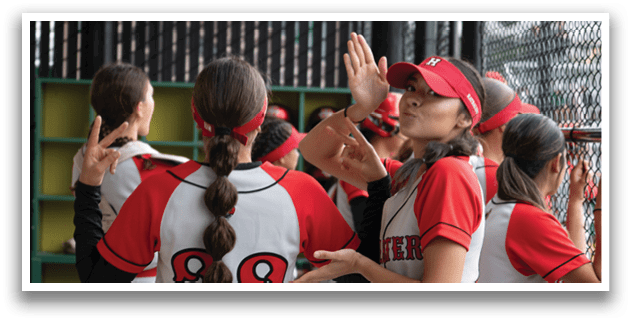 A group of girls wearing red and white uniforms. Description generated by AI