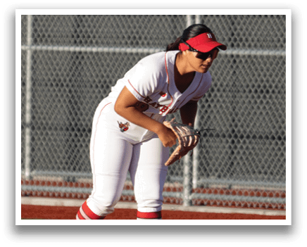 A girl in a red and white uniform is playing baseball. Description generated by AI
