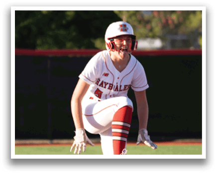 A baseball player in a red and white uniform is standing on one leg on the field. Description generated by AI