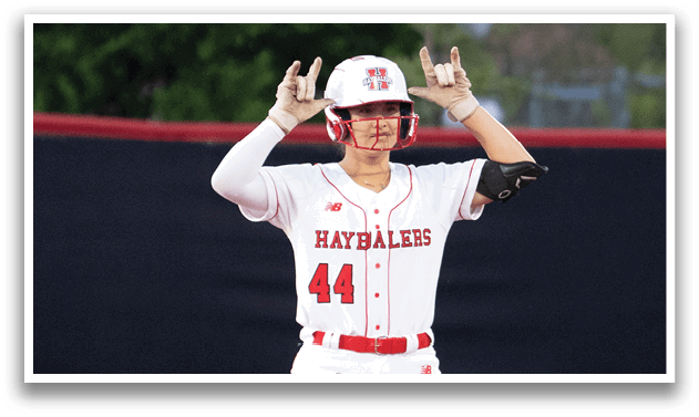 A baseball player is standing on the field with his arms raised. Description generated by AI