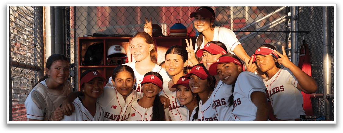 A group of girls wearing red and white uniforms. Description generated by AI