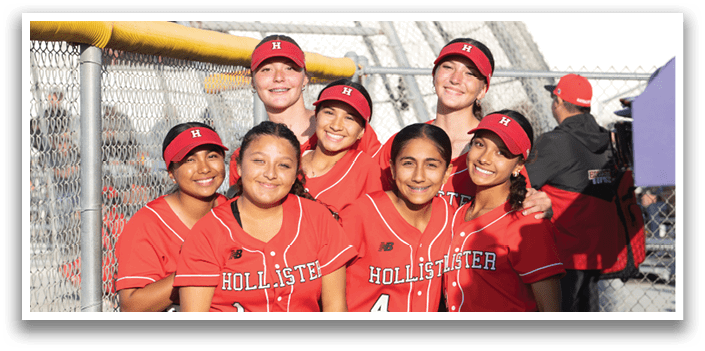 A group of girls wearing red and black jerseys. Description generated by AI
