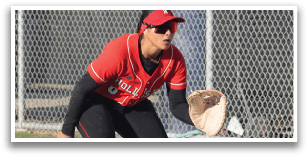 A woman wearing a red shirt and black pants is playing baseball. Description generated by AI
