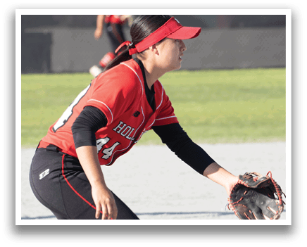A girl in a red shirt and black shorts catching a ball. Description generated by AI