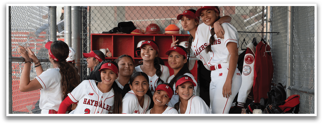 A group of girls wearing red and white uniforms. Description generated by AI