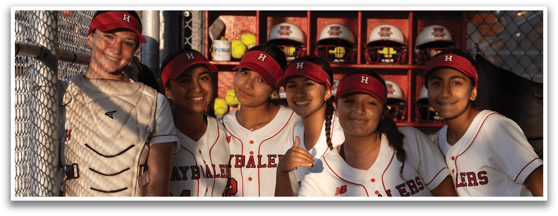 A group of girls wearing red and white uniforms. Description generated by AI