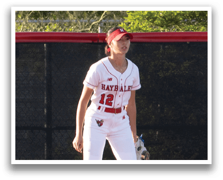 A baseball player is standing on the pitcher's mound. Description generated by AI
