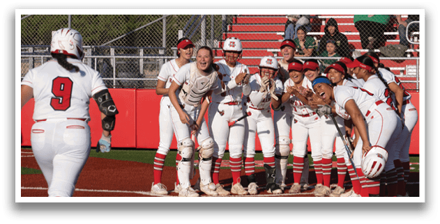 A group of girls are hugging each other on a baseball field. Description generated by AI