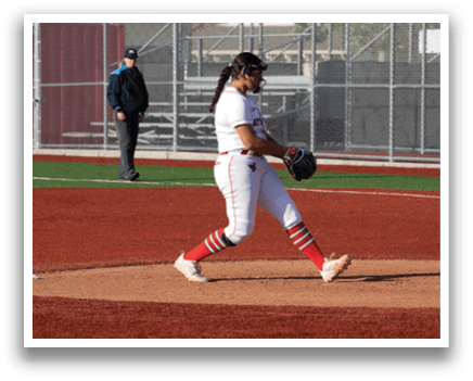 A woman wearing a red and white uniform is pitching a baseball. Description generated by AI