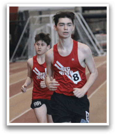 Two runners are on a track, one in the lead. A man in a grey shirt is standing behind the runner in the lead. AI generated content