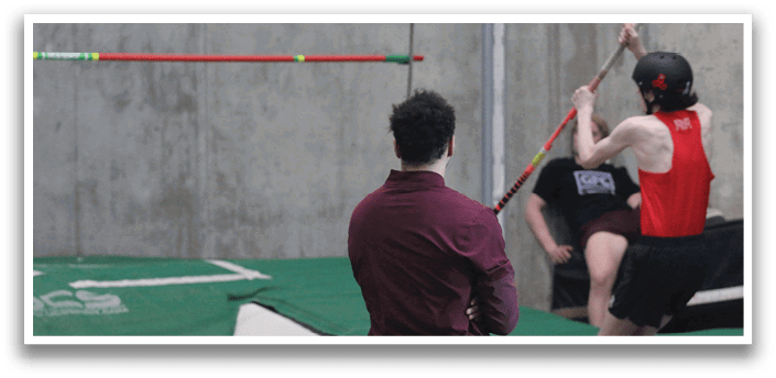 A man is jumping over a barrier while another man watches. AI generated content