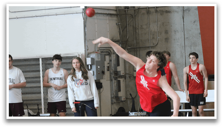 A man is throwing a red ball in a gym while a group of people watch. AI generated content