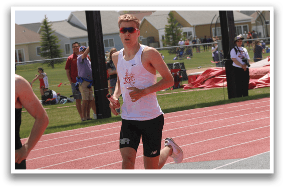 Two men running on a track. Description generated by AI
