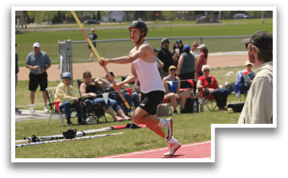 A man is running on a track with a pole in his hand. Description generated by AI