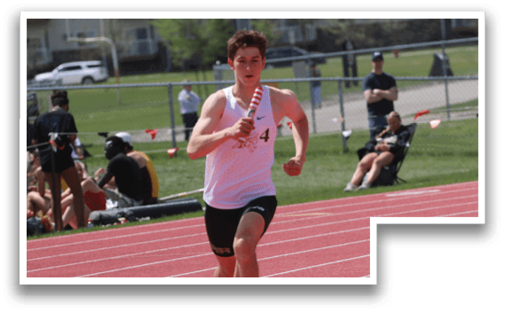 A man running on a track with orange cones. Description generated by AI