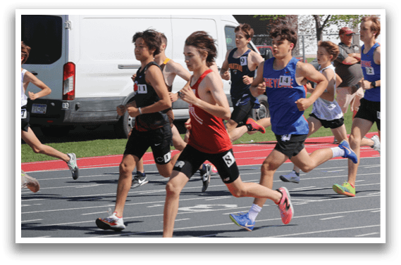 A group of people running on a track. Description generated by AI
