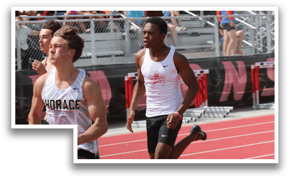 A group of men running on a track. Description generated by AI