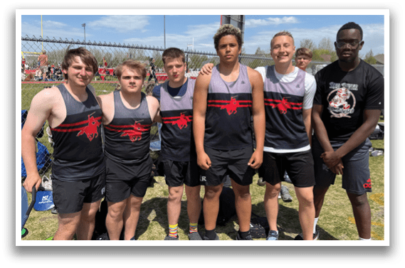 A group of young men wearing black and red shirts. Description generated by AI
