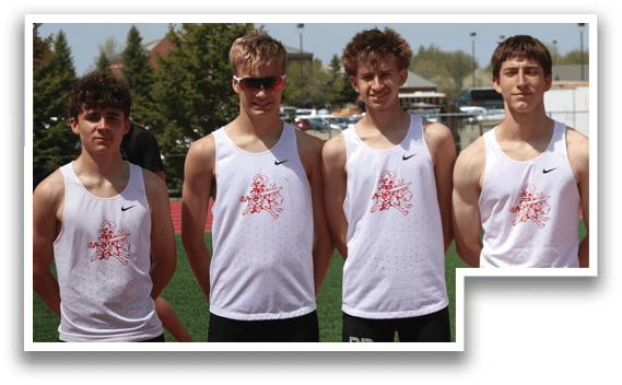 Four young men wearing white shirts and black shorts. Description generated by AI