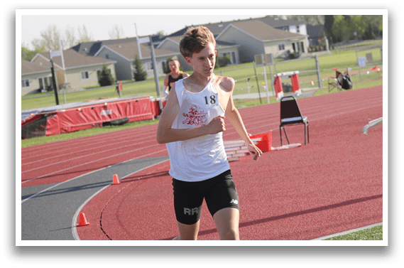 A boy running on a track. Description generated by AI