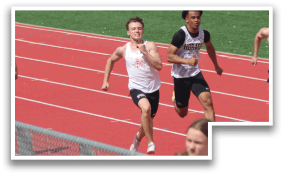 A group of people running on a track. Description generated by AI