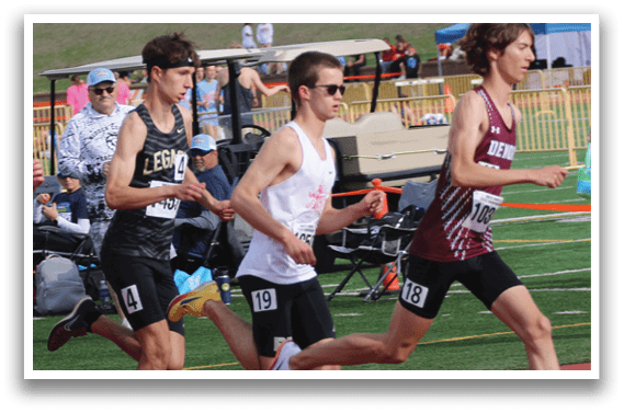 A group of runners are running on a track. Description generated by AI