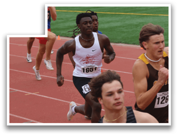 A runner wearing a black shirt and number 1414. Description generated by AI