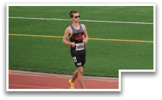 A man running on a track. Description generated by AI