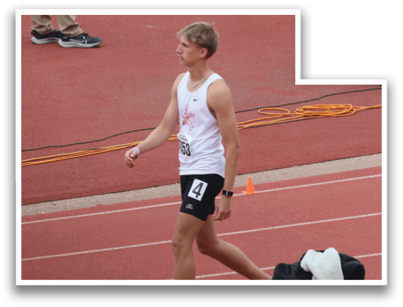 A man is running on a track. Description generated by AI