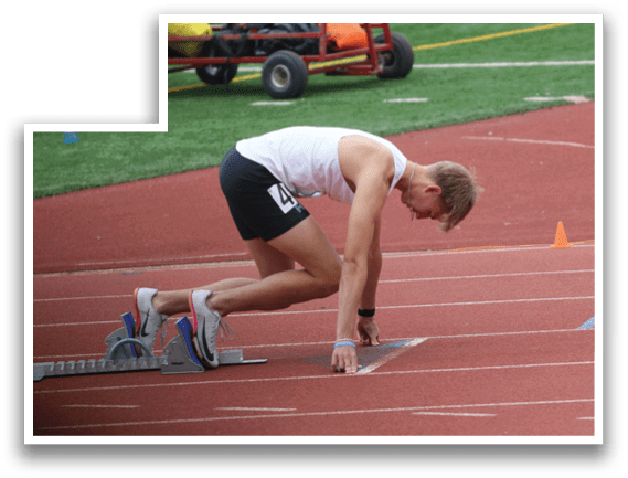 A man is bending over on a track. Description generated by AI