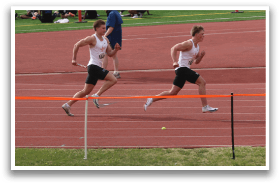 A group of people running on a track. Description generated by AI