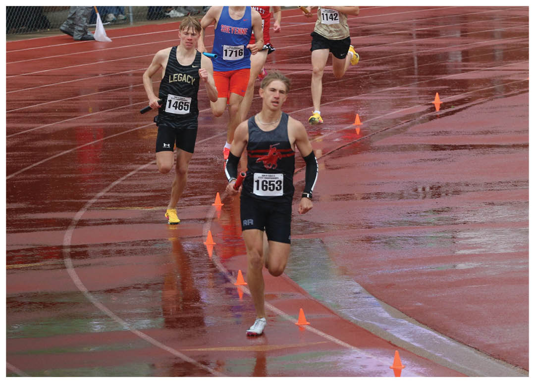 A group of people running on a track. Description generated by AI