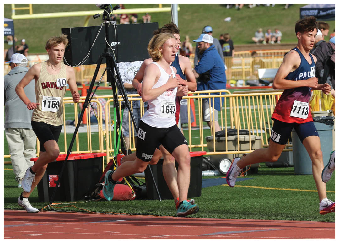 A group of runners are running on a track. Description generated by AI