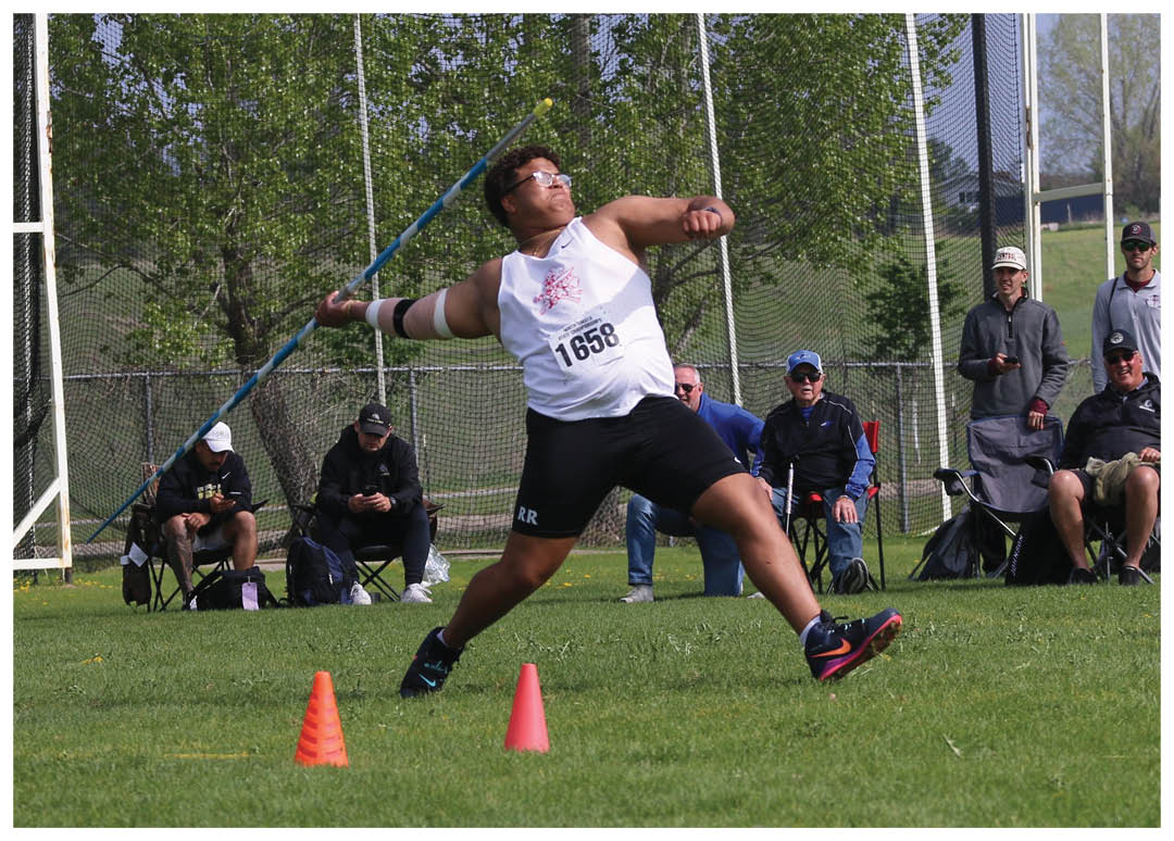 A man is throwing a frisbee in a field. Description generated by AI