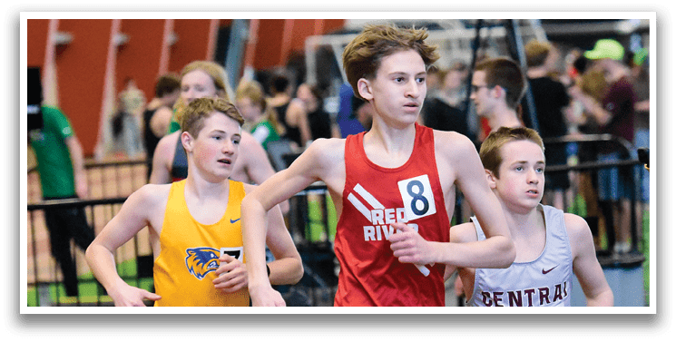Three young boys are running on a track, wearing uniforms and racing each other. AI generated content
