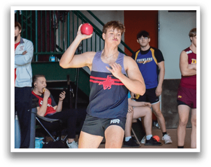 A man is throwing a ball in a gym while a group of people watch. AI generated content